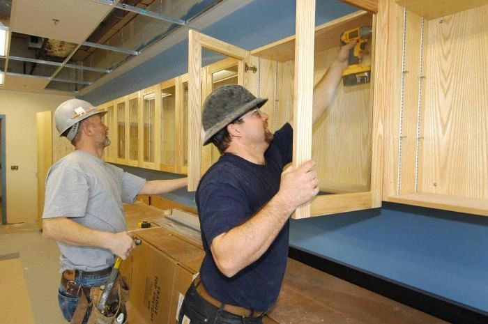 Cabinet installers at work